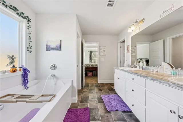 a bathroom with a double vanity sink mirror and shower