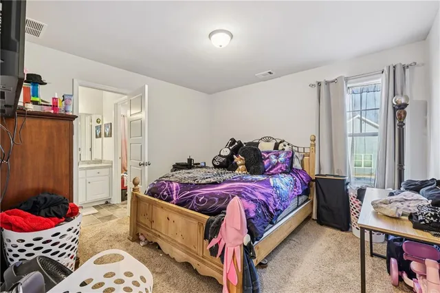 a bedroom with bed and a window