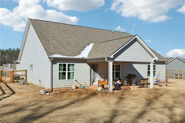 a view of a house with wooden fence