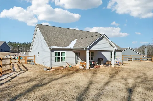 a view of a house with cars park next to a road