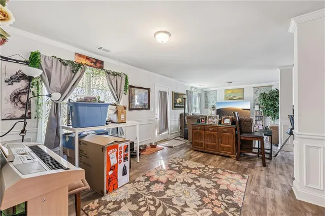 a living room with furniture and a wooden floor