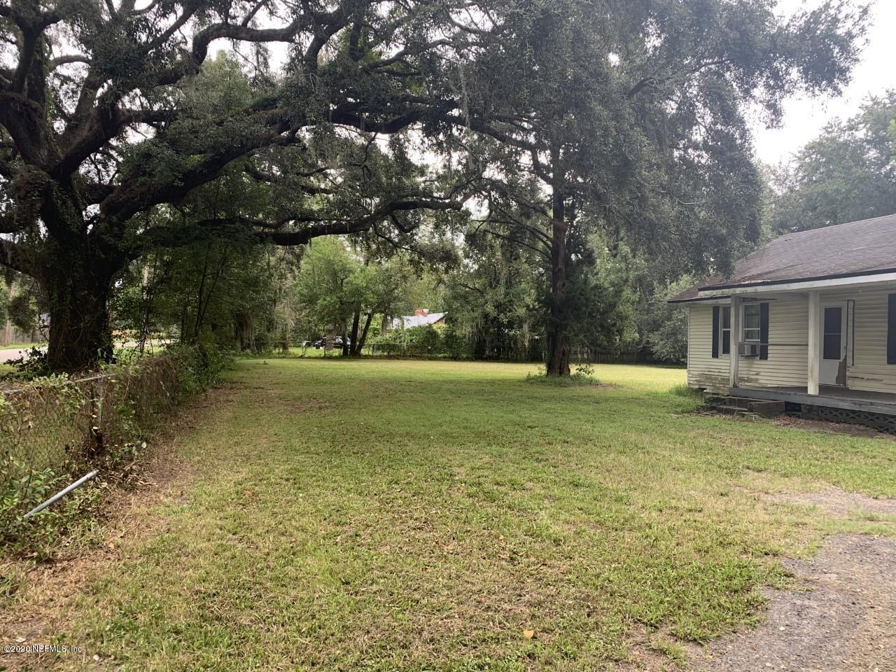 4829 Firestone Road Jacksonville, FL 32210 - Photo 3 of 6 a view of a house with yard and tree s
