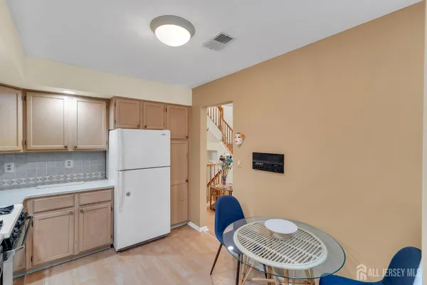 a kitchen with stainless steel appliances a refrigerator and a stove top oven