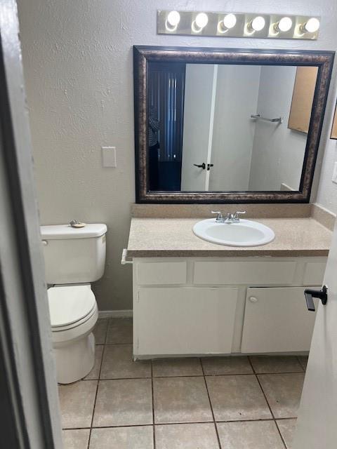 4040 Brown Street, Unit 9 Dallas, TX 75219 - Photo 11 of 11 a bathroom with a toilet sink and mirror