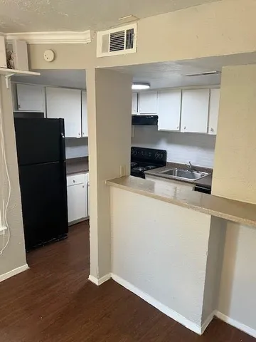 a kitchen with a refrigerator and a stove