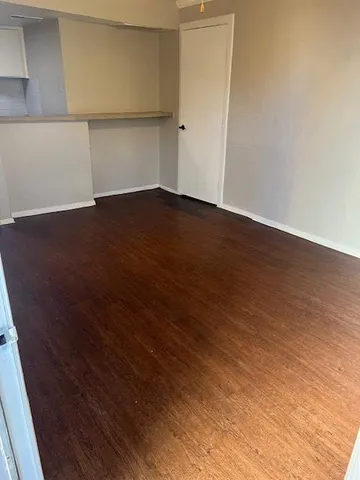 an empty room with wooden floor