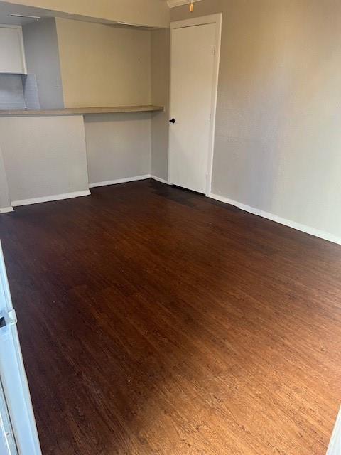 4040 Brown Street, Unit 9 Dallas, TX 75219 - Photo 5 of 11 an empty room with wooden floor