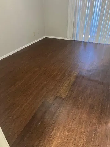 a view of room with wooden floor