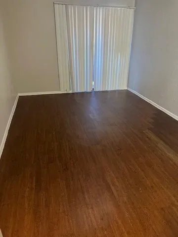 a view of wooden floor and brick wall