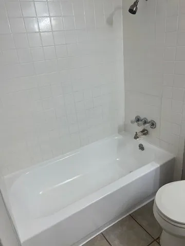 a bathroom with a bathtub and toilet