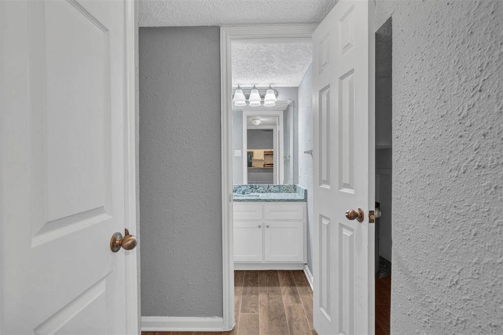 11311 Audelia Road, Unit 221 Dallas, TX 75243 - Photo 15 of 22 a bathroom with a granite countertop sink and a mirror
