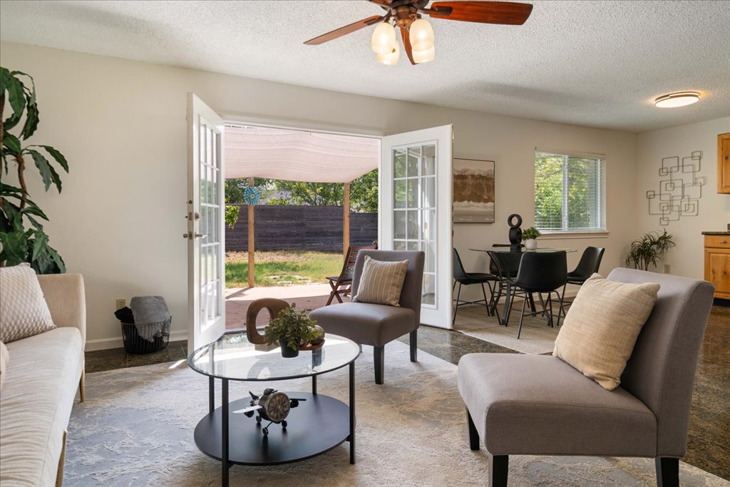6308 Shadow Bend Austin, TX 78745 - Photo 1 of 1 Living room featuring a textured ceiling, french doors, and a ceiling fan
