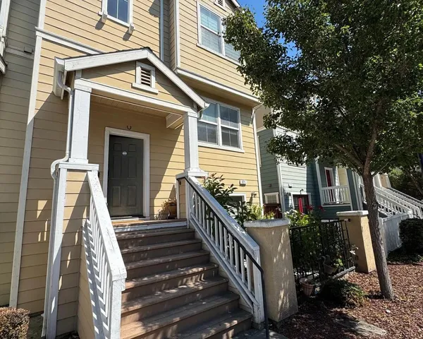 a view of a house with backyard and deck