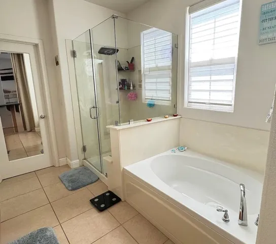 a bathroom with a bathtub and a shower
