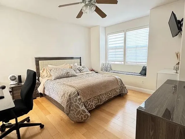 a bedroom with a bed and a chandelier