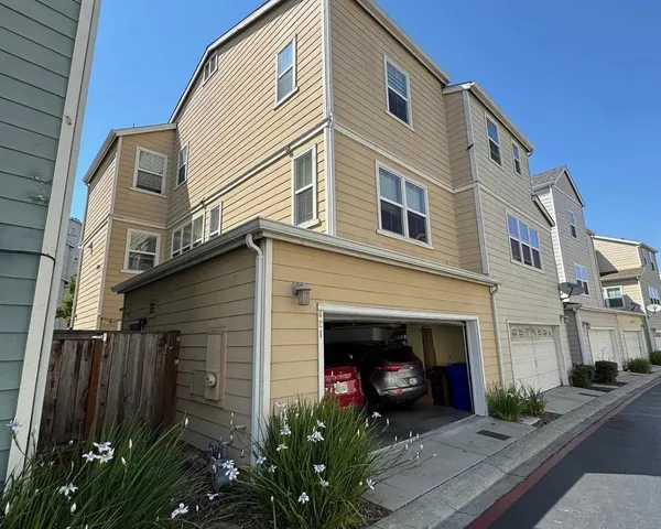 a view of a house with a yard and plants