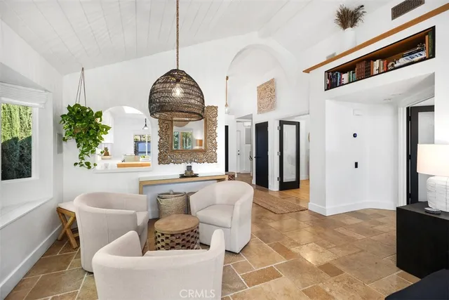 a living room with fireplace furniture and a large window