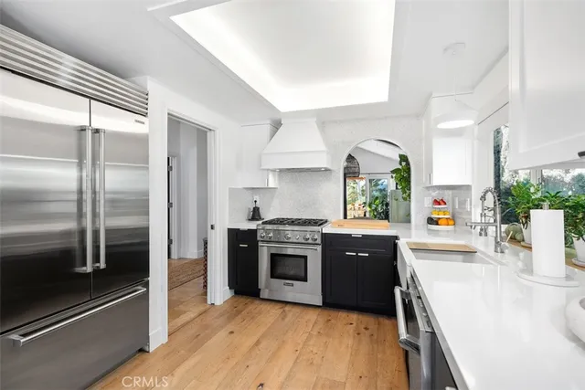 a kitchen with a stove a sink and a cabinets