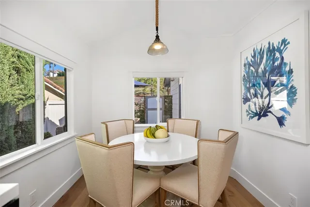 a living room with furniture a large window and white walls