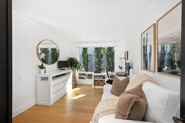 a living room with furniture and large windows