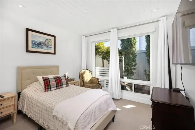 a bedroom with a bed and chair