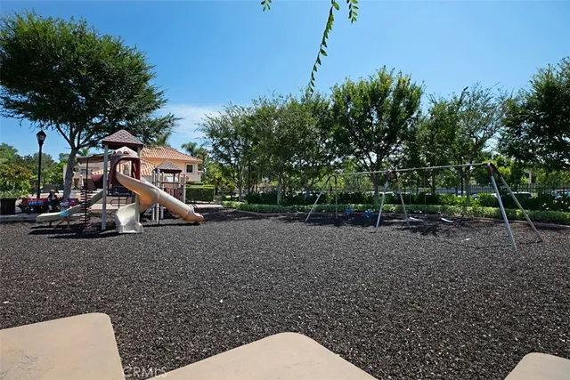 a view of a tennis ground with large trees