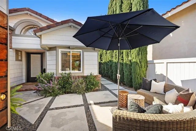 a view of a house with a yard and furniture