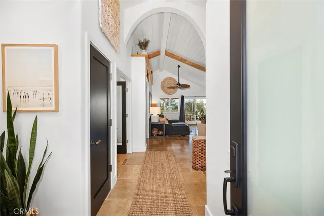 a living room with furniture kitchen and a chandelier