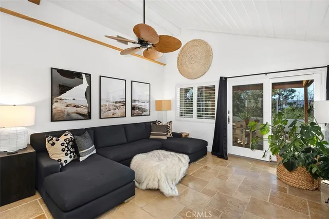 a living room with furniture a window and a chandelier