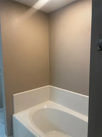 a white bath tub sitting in a bathroom