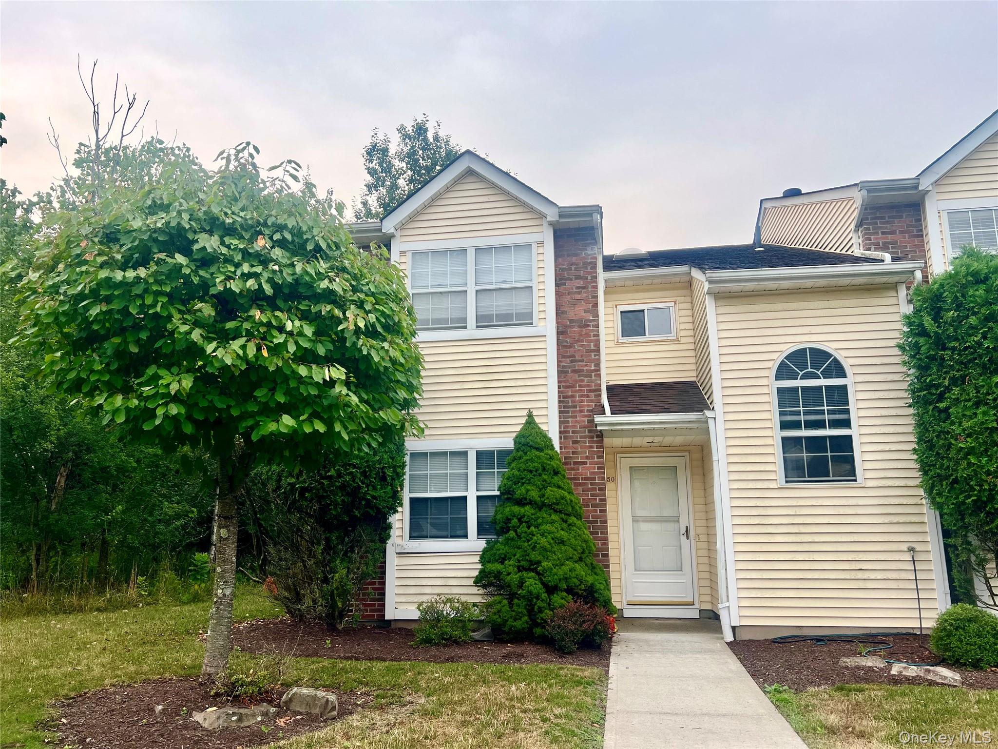 a view of a house with a yard