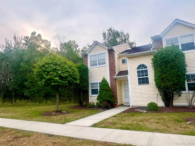 a view of a house with a yard and plants