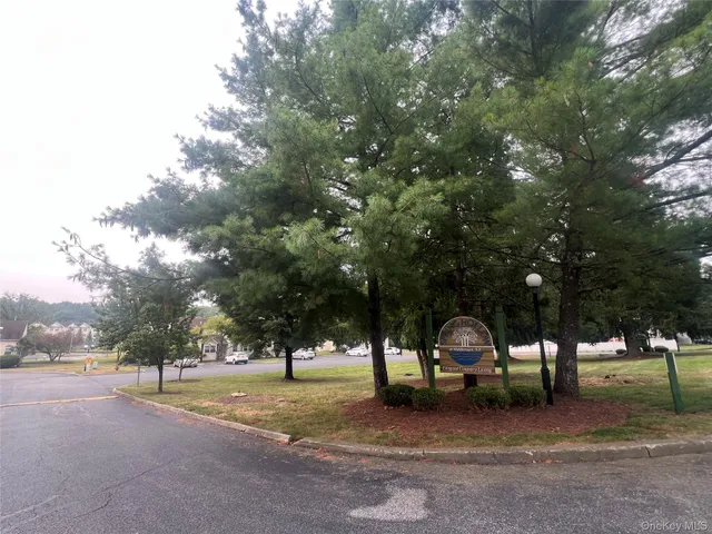 a view of a house with large trees