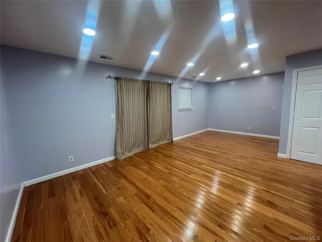 an empty room with wooden floor