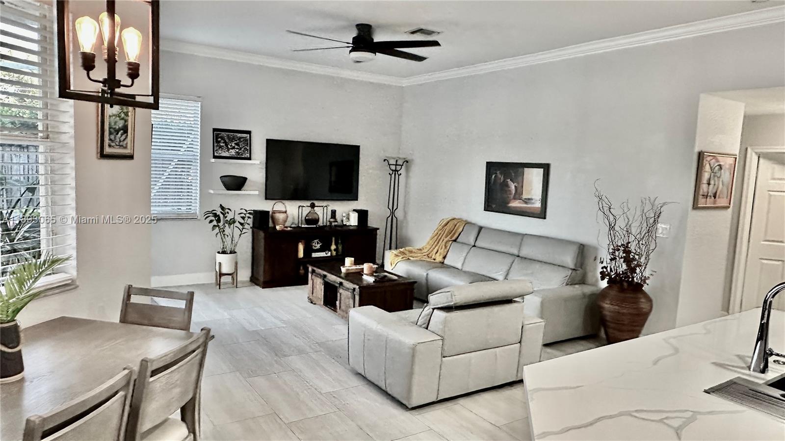 1335 East Barwick Ranch Circle Delray Beach, FL 33445 - Photo 15 of 33 a living room with furniture a flat screen tv and a fireplace