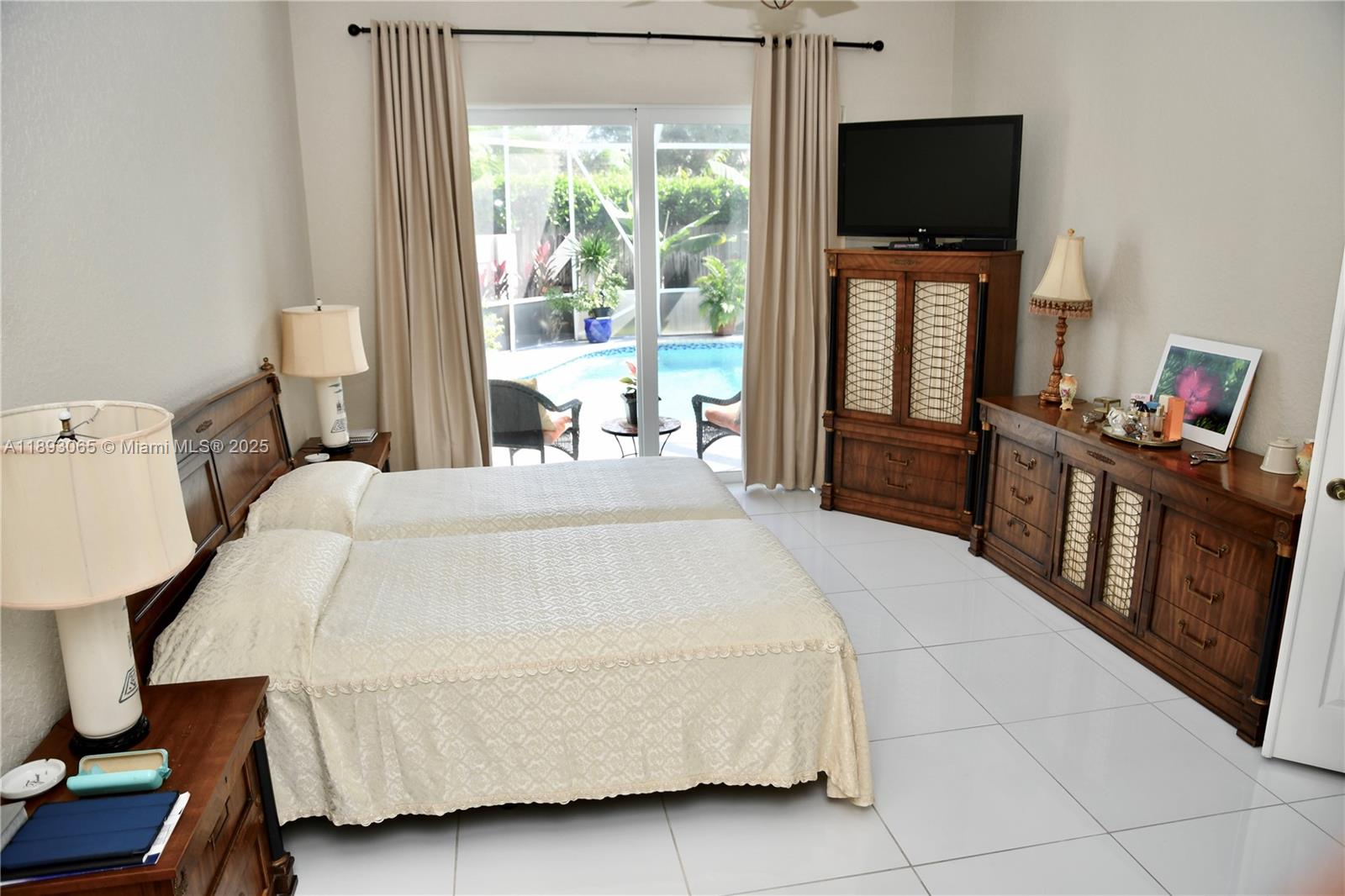1335 East Barwick Ranch Circle Delray Beach, FL 33445 - Photo 18 of 33 a bedroom with a bed and a flat screen tv