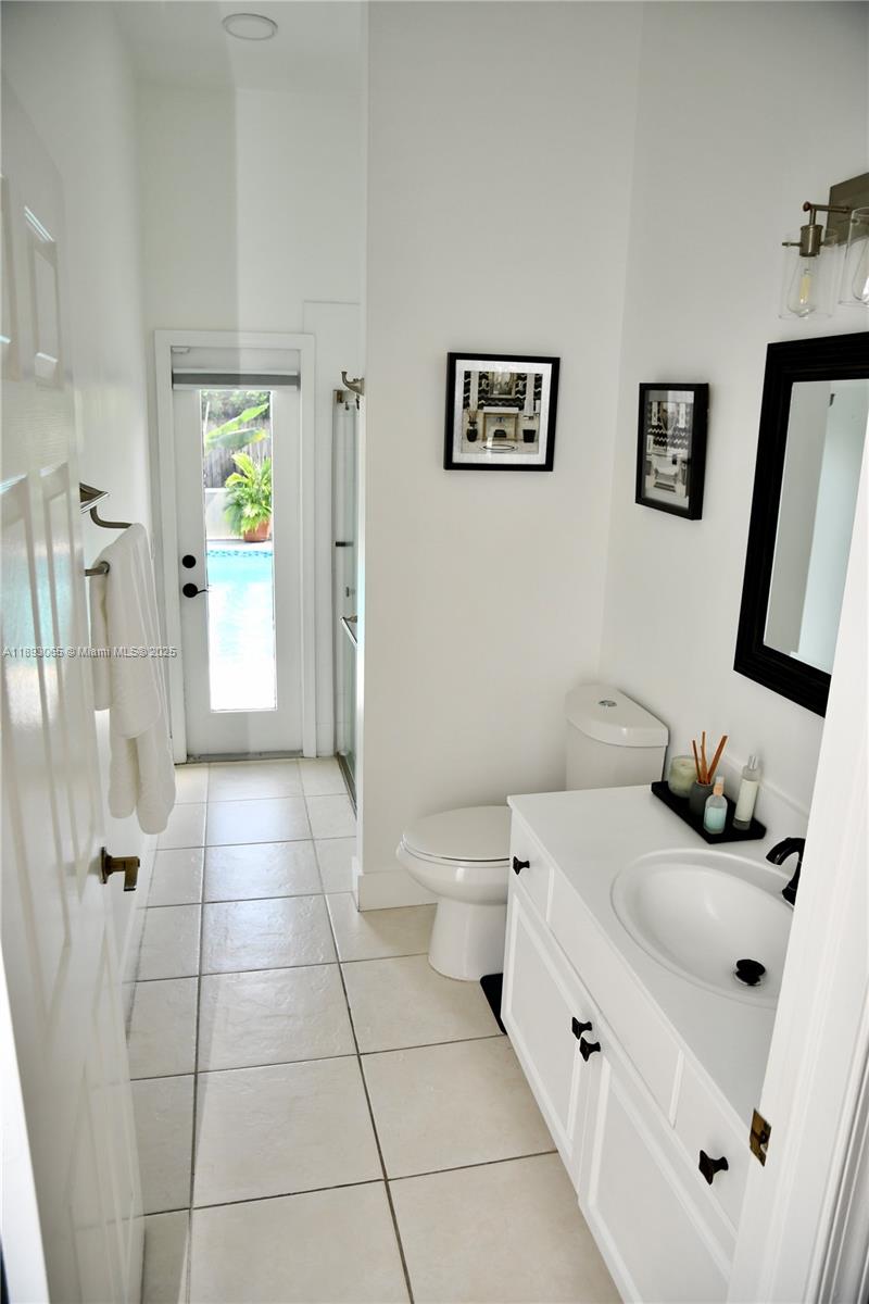 1335 East Barwick Ranch Circle Delray Beach, FL 33445 - Photo 23 of 33 a bathroom with a double vanity sink toilet and shower