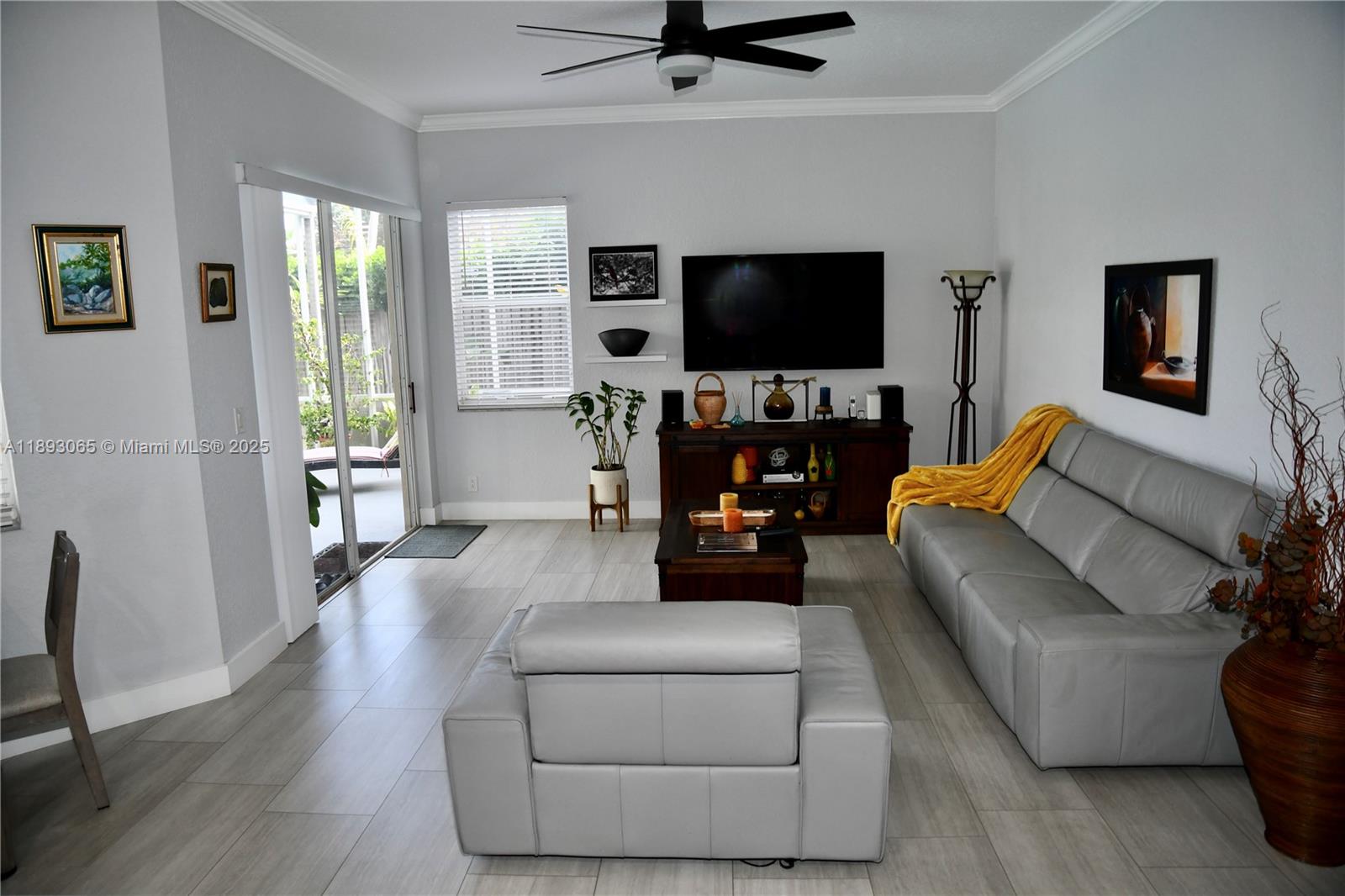1335 East Barwick Ranch Circle Delray Beach, FL 33445 - Photo 29 of 33 a living room with furniture and a flat screen tv