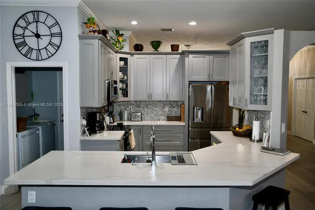 a kitchen with a refrigerator and a sink