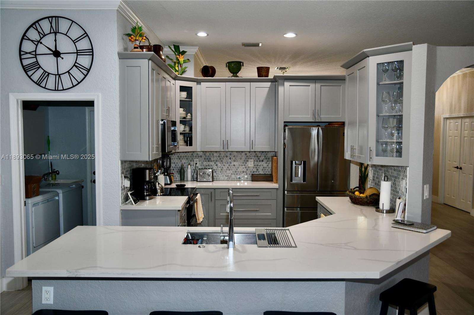 1335 East Barwick Ranch Circle Delray Beach, FL 33445 - Photo 30 of 33 a kitchen with a refrigerator and a sink