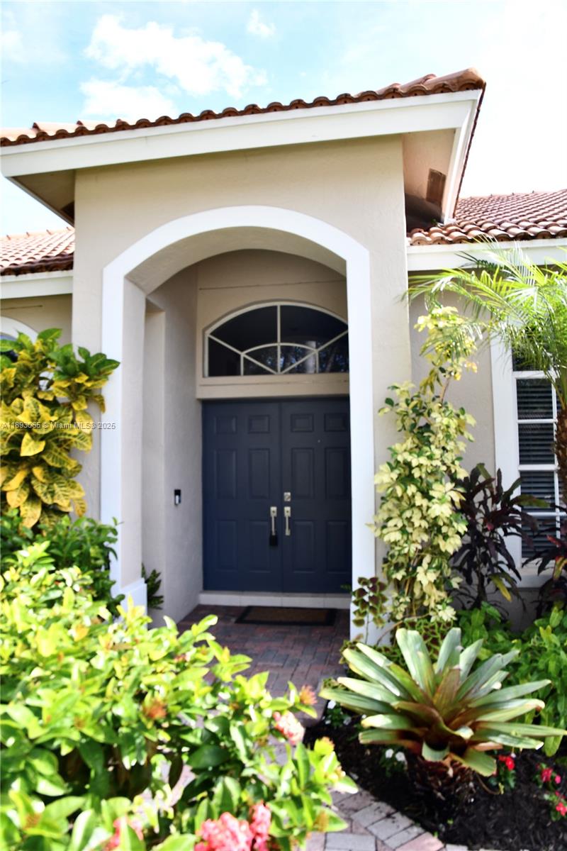 1335 East Barwick Ranch Circle Delray Beach, FL 33445 - Photo 5 of 33 a front view of a house with a yard