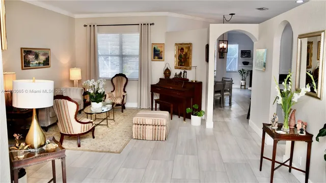 a living room with furniture a dining table and wooden floor