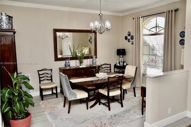 a view of a dining room with furniture and a chandelier