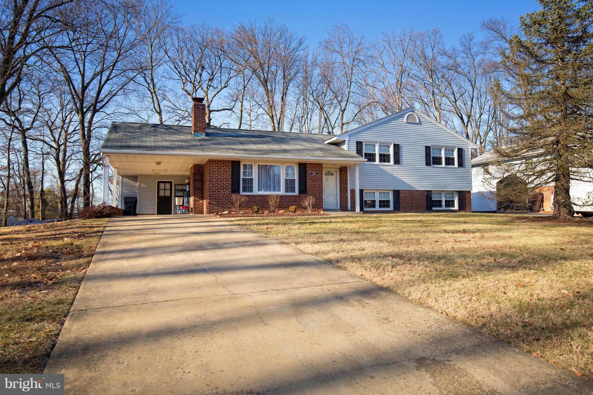 5227 Milland Street Springfield, VA 22151 - Photo 1 of 28 a view of a white house with a large tree