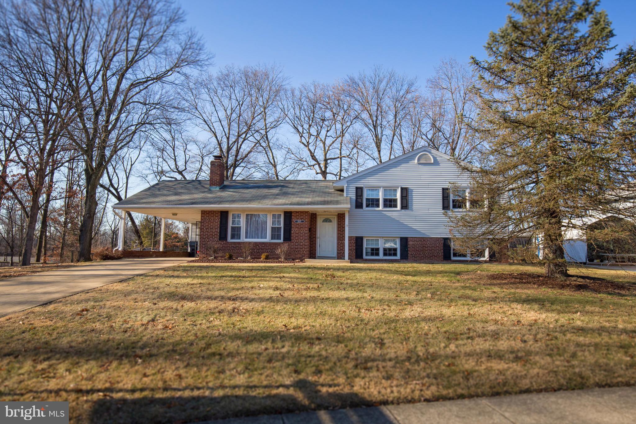 5227 Milland Street Springfield, VA 22151 - Photo 2 of 28 a front view of a building with a garden