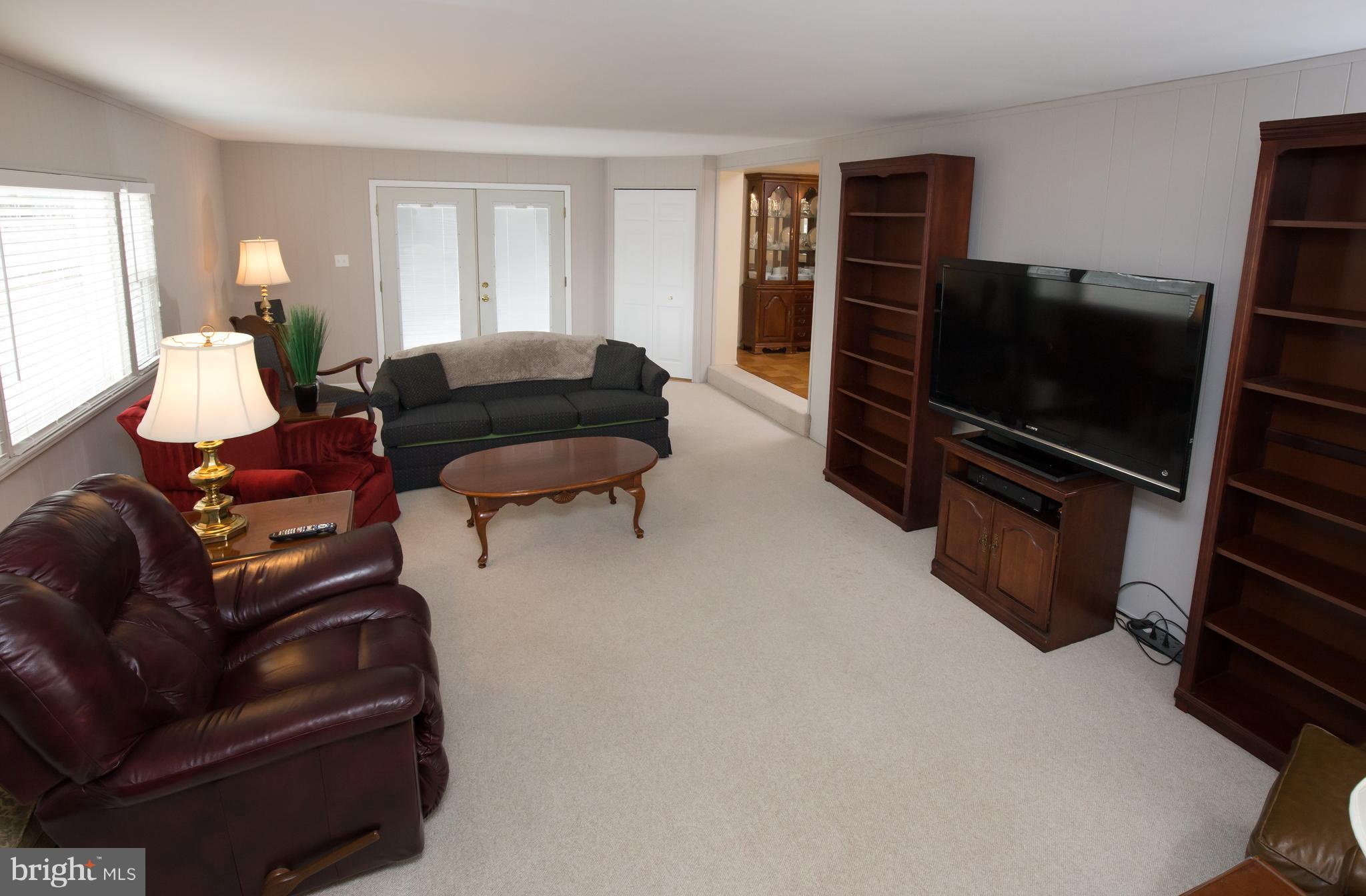 5227 Milland Street Springfield, VA 22151 - Photo 11 of 28 a living room with furniture and a flat screen tv