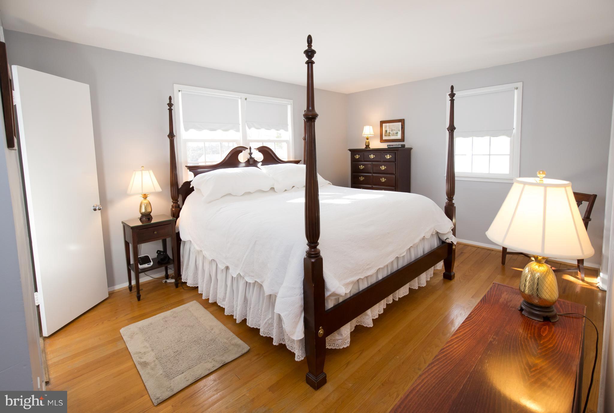 5227 Milland Street Springfield, VA 22151 - Photo 15 of 28 a bed room with a bed and a lamp