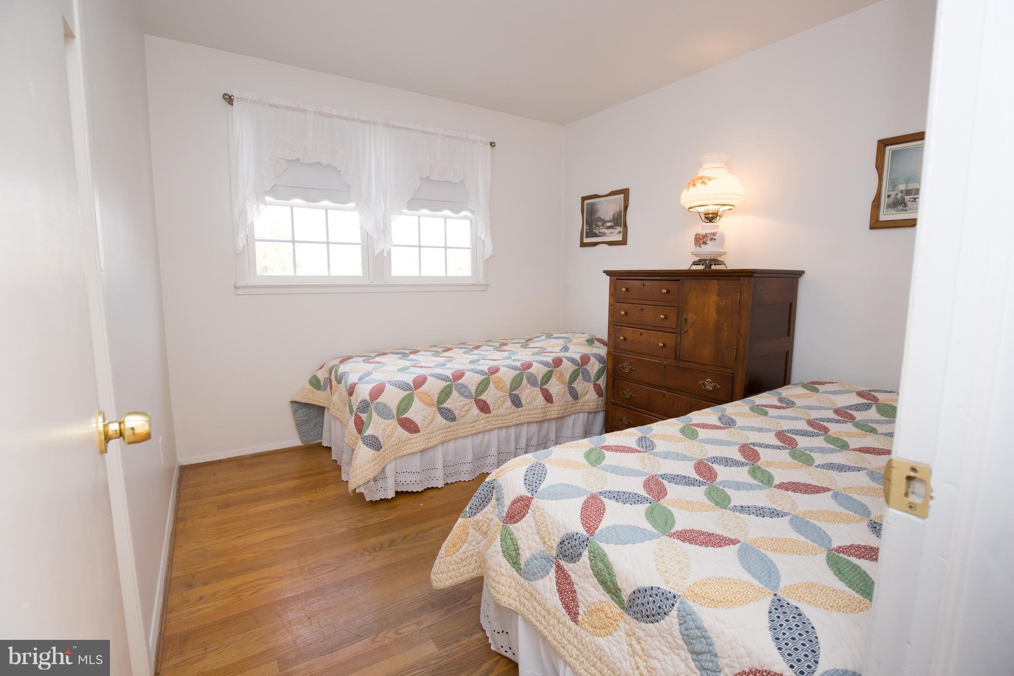 5227 Milland Street Springfield, VA 22151 - Photo 18 of 28 a bedroom with two beds and wooden floor