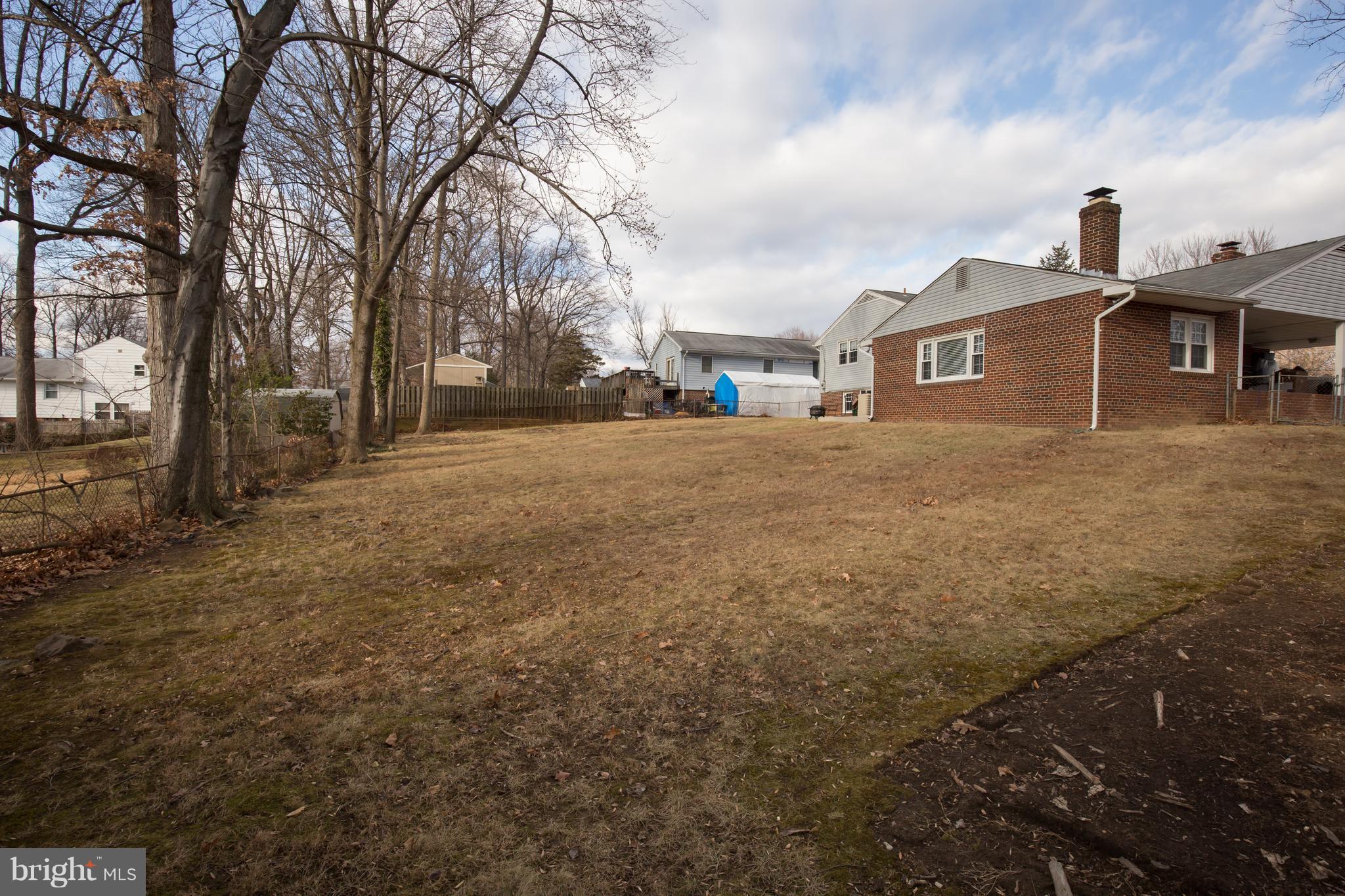 5227 Milland Street Springfield, VA 22151 - Photo 26 of 28 a front view of a house with a yard and garage