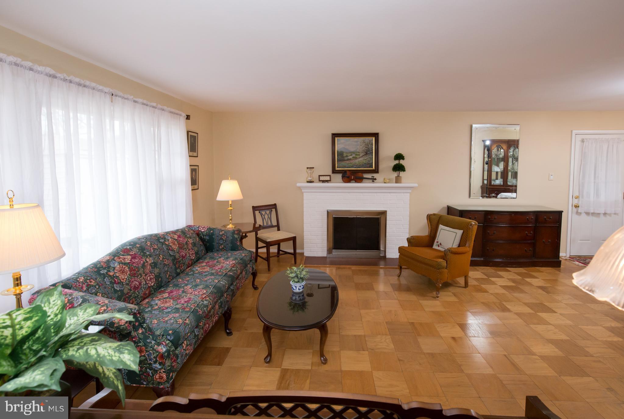 5227 Milland Street Springfield, VA 22151 - Photo 4 of 28 a living room with furniture a fireplace and a window